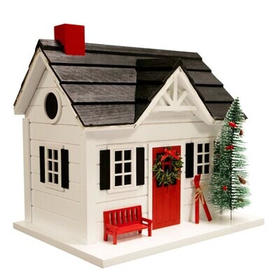 Angled view of the holiday birdhouse showing the roof and decorative pine tree.