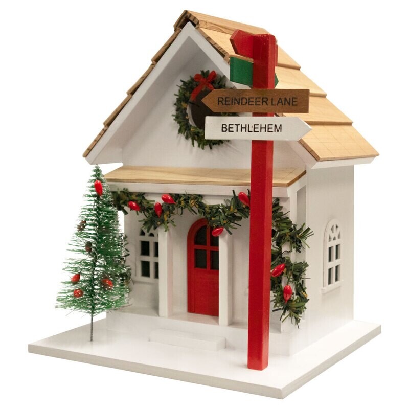 Front view of the Sign Post Holiday House with a shingled roof and festive greenery.