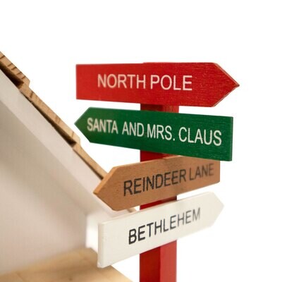 Close-up of the directional signpost pointing to North Pole, Reindeer Lane, and Bethlehem.