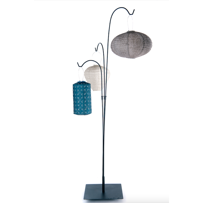 Black metal Lumiz terrace stand with multiple curved hooks and square freestanding base. Lanterns are hanging on stand.