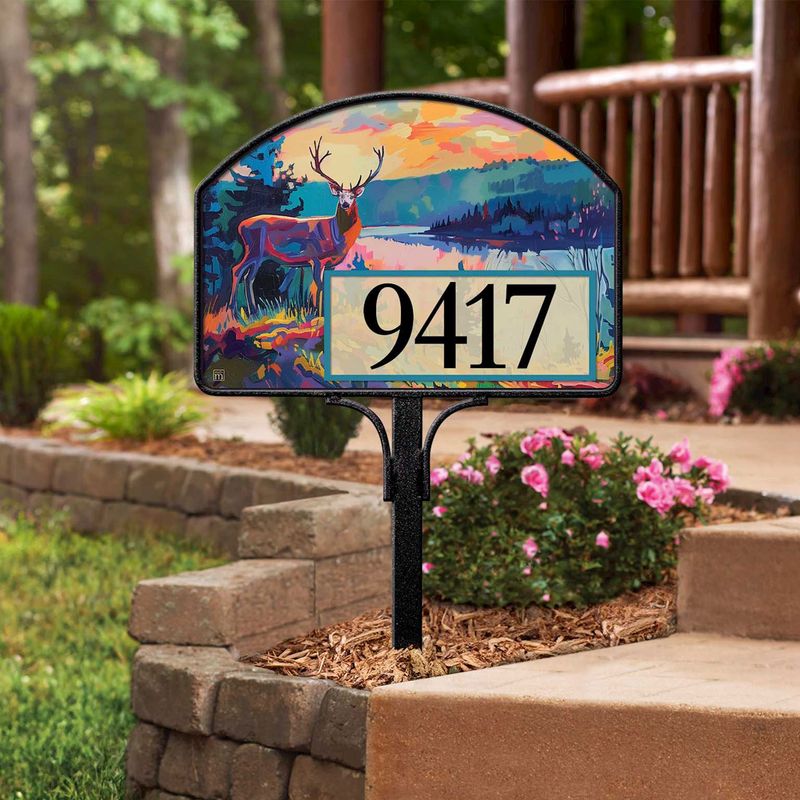 Magnetic yard sign featuring a majestic deer and address numbers, installed in a garden setting.