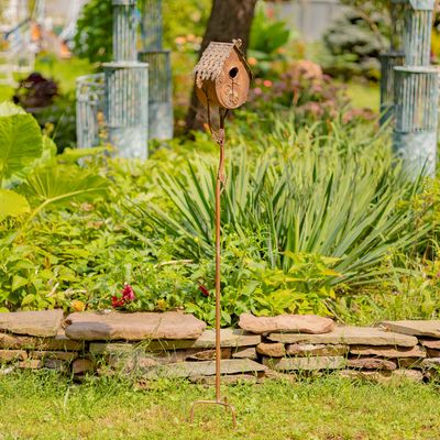 Full studio shot of the 64.5-inch tall farmhouse-style birdhouse on its matching decorative iron stake.