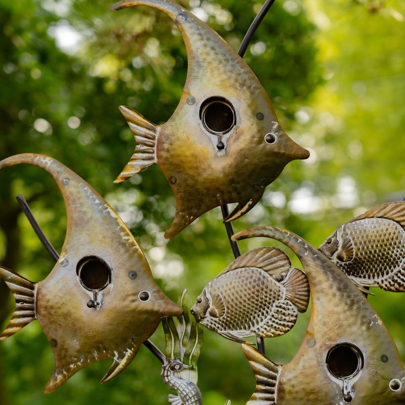 Close-up of the hand-painted metal angelfish birdhouse showing the 1.5-inch entry hole and round perch.