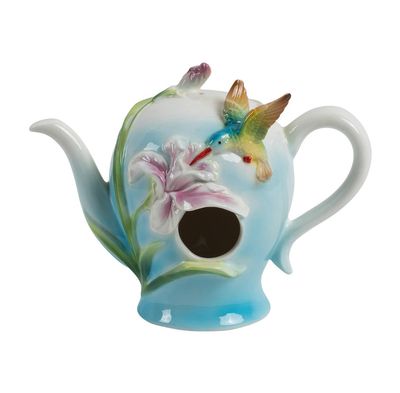 Front view of the Tiffany teapot birdhouse showing the round entry hole and hand-painted floral details.