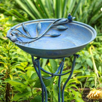 Side view of the frosted blue iron birdbath featuring a scalloped basin and decorative stand.