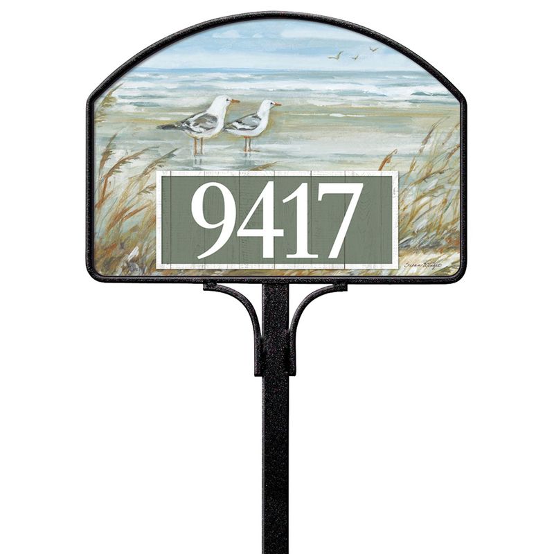 Magnetic yard sign featuring flying seagulls and address numbers, installed on a metal stake outdoors.
