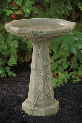Large stone-look birdbath with a green moss finish and a pedestal featuring sculpted vine and leaf details.