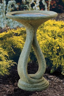 Sculptural bird bath with a brown stone finish and a graceful, flowing ribbon-style pedestal base.