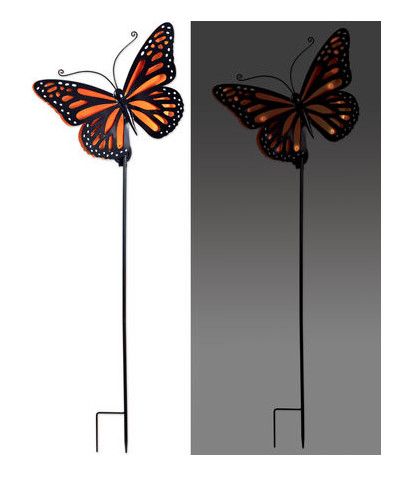 Orange butterfly solar garden stake with metal pole shown illuminated at night and unlit during the day.