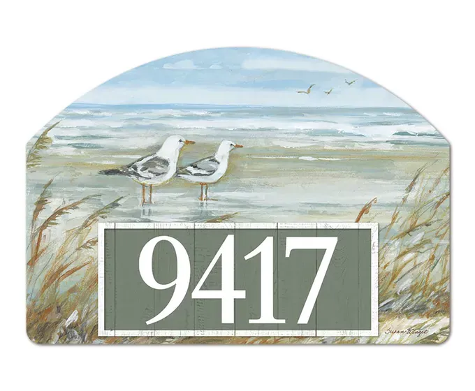 Close-up of magnetic yard sign featuring a coastal seagull design and adhesive address numbers.