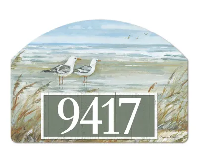 Close-up of magnetic yard sign featuring a coastal seagull design and adhesive address numbers.