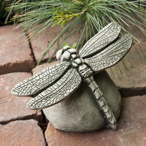DRAGONFLY ON ROCK STATUE
