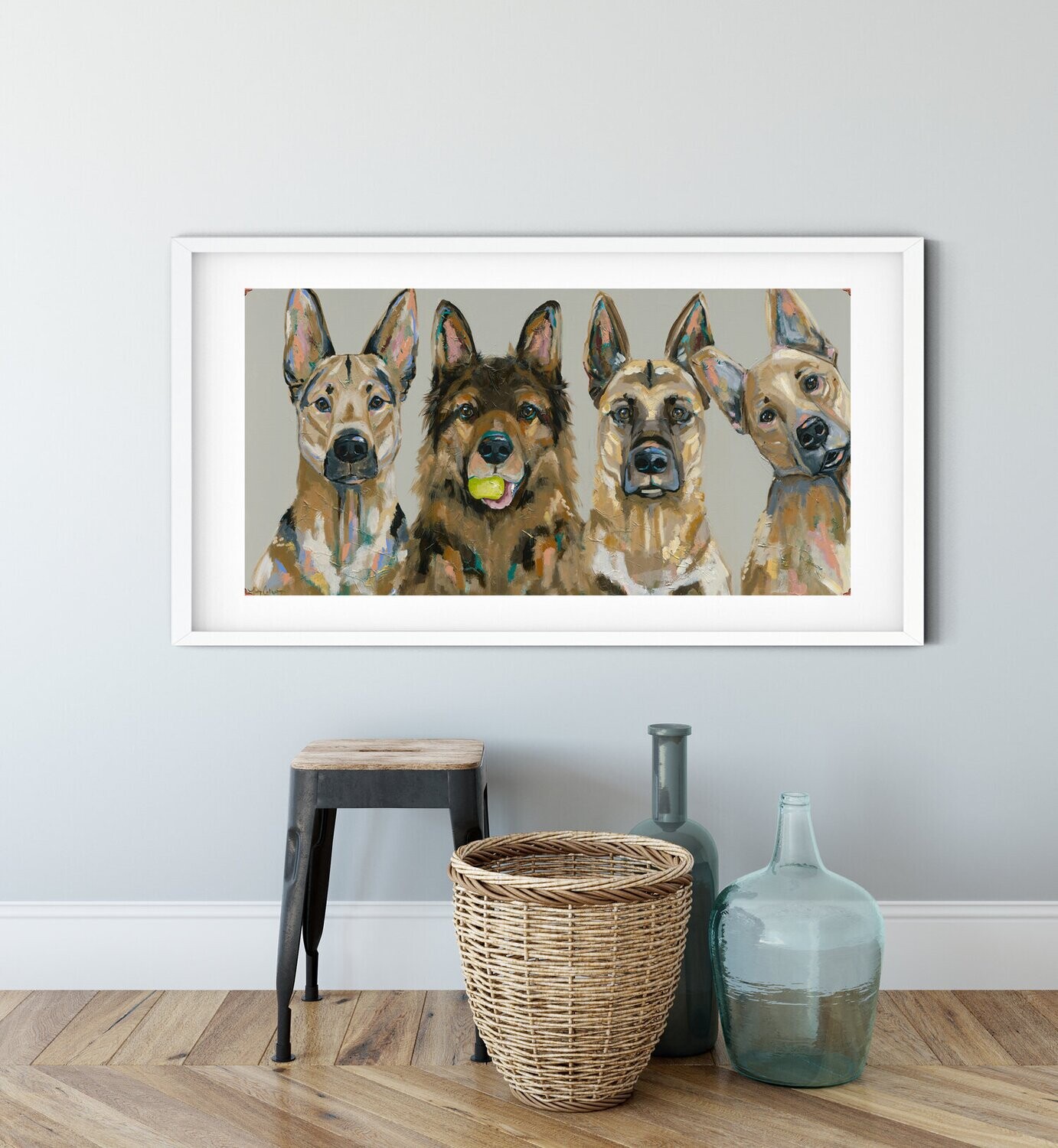 Framed version of the three birds art print sitting on a wooden bench next to a decorative vase in a modern home entryway.