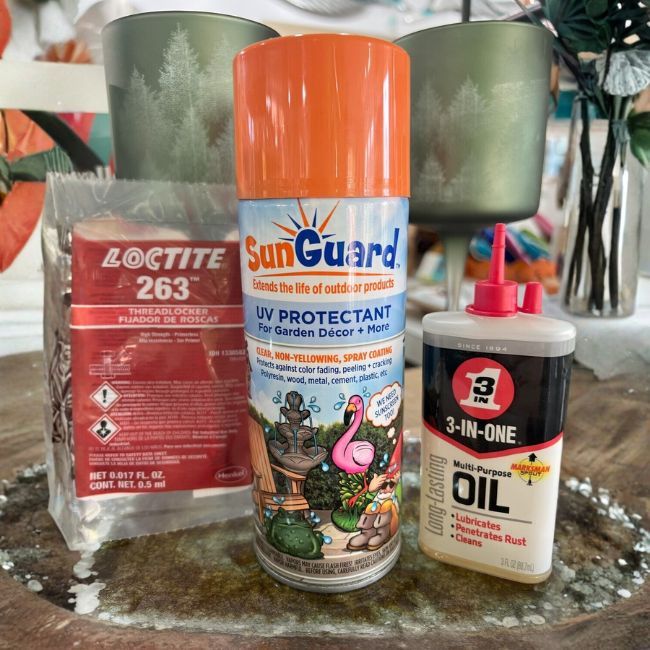Outdoor décor care kit with SunGuard UV Protectant spray, Loctite Blue threadlocker, and 3-IN-ONE oil bottle.