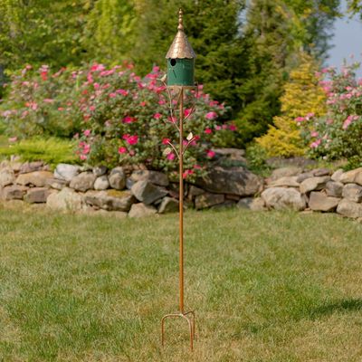Full-length shot of the 68.75-inch tall birdhouse stake set against a garden background, highlighting the distressed antique 