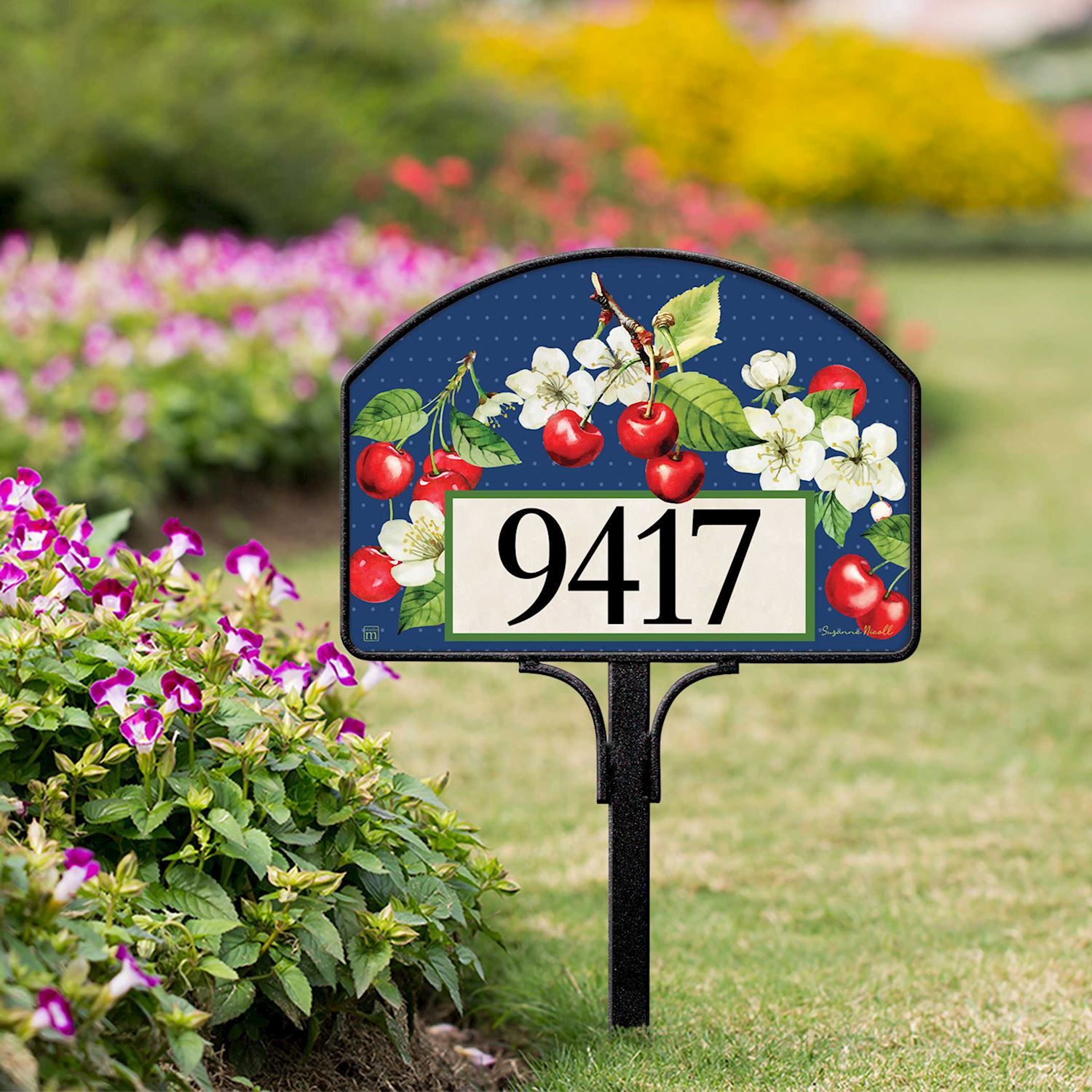 Magnetic yard sign featuring sweet cherries and address numbers, installed on a metal stake in a garden.