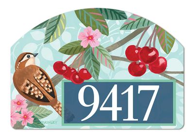 Close-up of magnetic yard sign design with birds, red cherries, and adhesive numbers for an address.