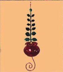 Red glass hummingbird feeder with a gold metal leaf wrap.