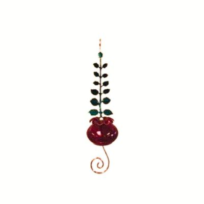 Red glass hummingbird feeder with a gold metal leaf wrap.