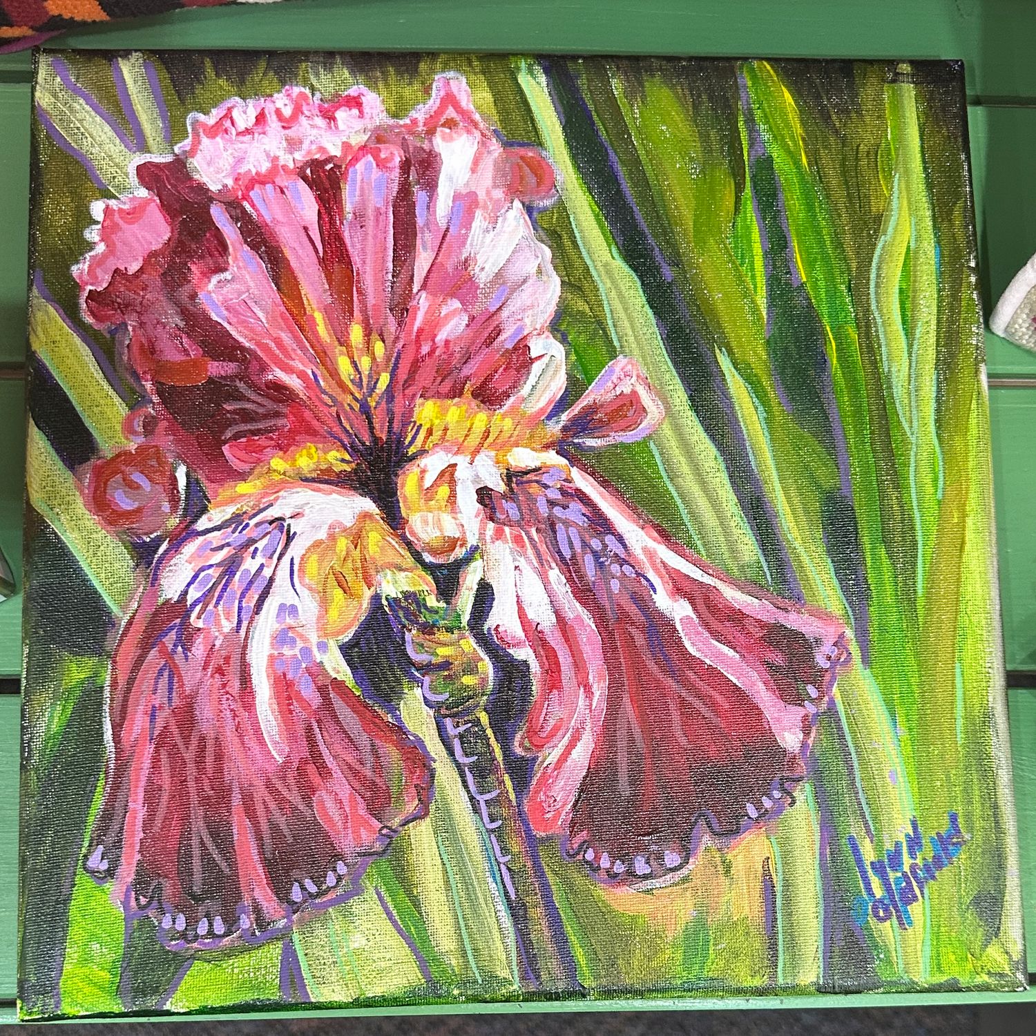 A vibrant 12x12 acrylic painting featuring a close-up of a purple and yellow iris flower with soft green