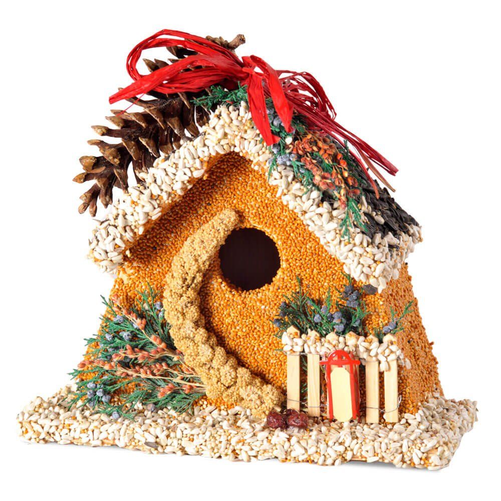 Chalet-style wooden birdhouse completely covered in premium edible birdseed with a sled and chimney detail.