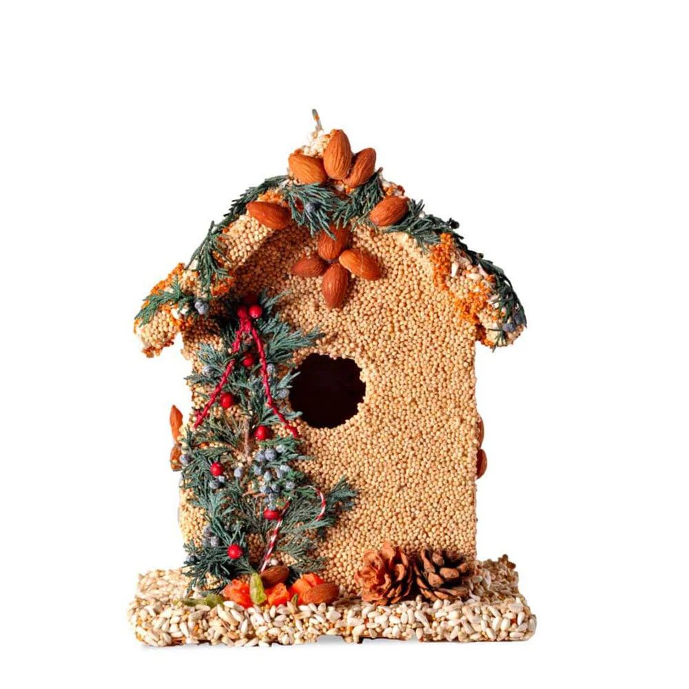 Seeded birdhouse with a brown roof, decorated with a pinecone, green sprigs, and a red bow.