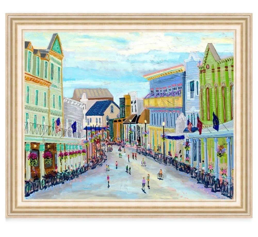 art print depicting a vibrant painting of historic buildings and visitors strolling along a sunny street on Mackinac Island.