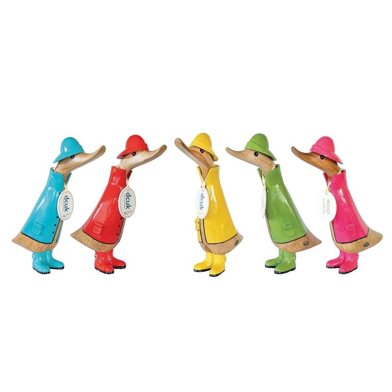 Hand-carved wooden DCUK duck figurines wearing colorful raincoats and hats in blue, red, yellow, green, and pink.
