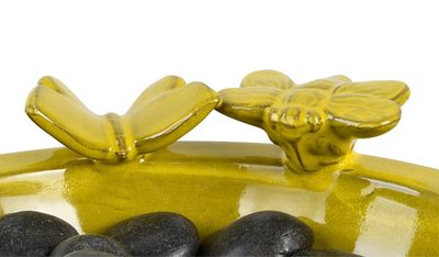 Close-up of the ceramic pollinator bath showing the included smooth river stones.