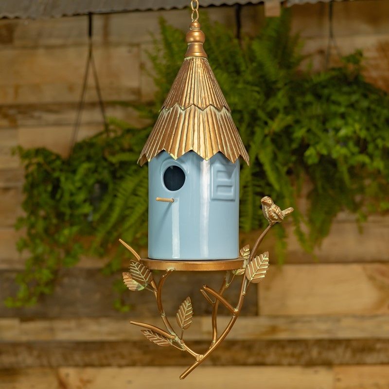 Soft blue porcelain hanging birdhouse with antique copper metal roof, decorative branches, leaves and perched bird accent.