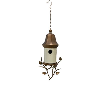 White porcelain hanging birdhouse with antique copper metal roof, decorative branches, leaves and small bird accent.