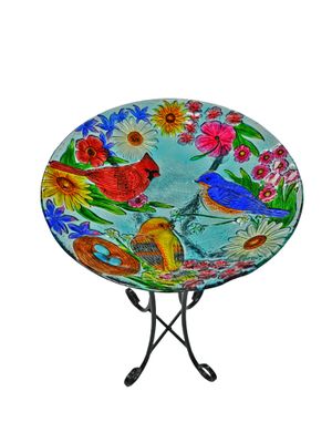 Profile view of the textured glass bird bath bowl showing the colorful songbird design.