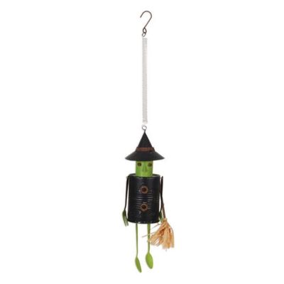 Rustic metal witch hanging decoration with spring and dangling green legs.