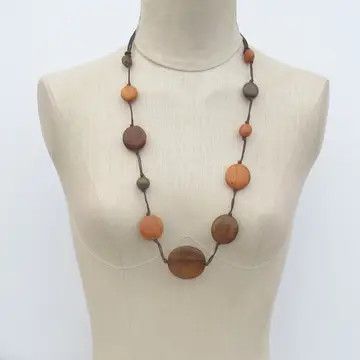 A handcrafted, metal-free necklace made of natural wood beads in warm brown, terracotta, and soft neutral tones