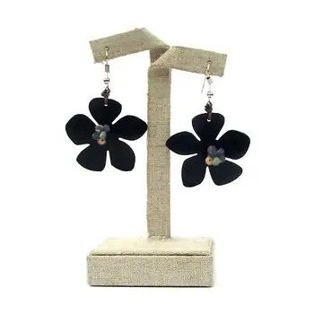 A pair of handcrafted flower-shaped drop earrings featuring five dark navy blue petals around a textured golden center