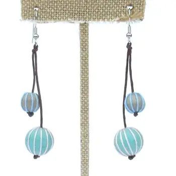 A pair of handcrafted drop earrings featuring light pastel blue and cream wooden beads