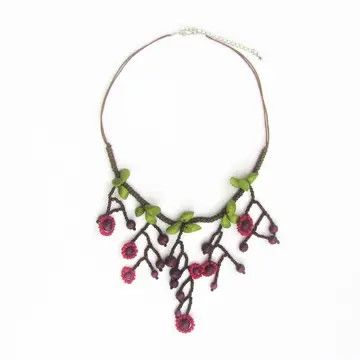 necklace featuring handcrafted Michigan-made wooden charms and accents in warm red, natural wood, and subtle green hues.