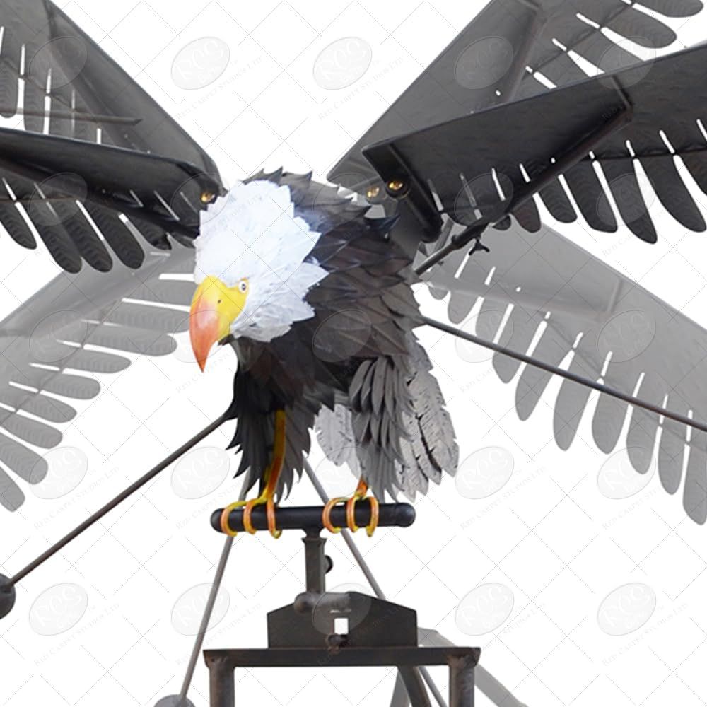 Large metal bald eagle garden rocker with outstretched wings mounted on tall six-prong ground stake.