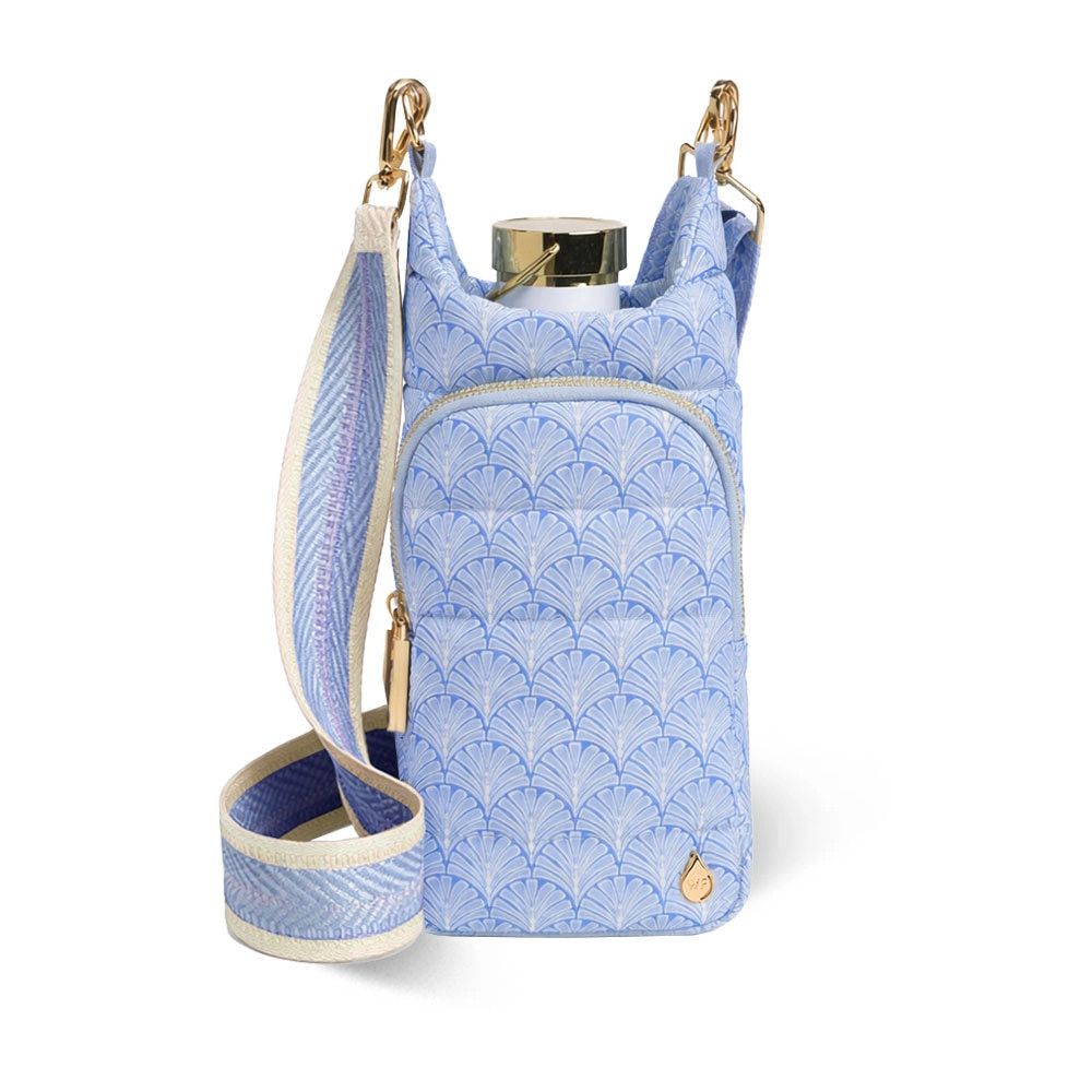 Blue scallop print quilted water bottle crossbody bag with woven strap and gold hardware.