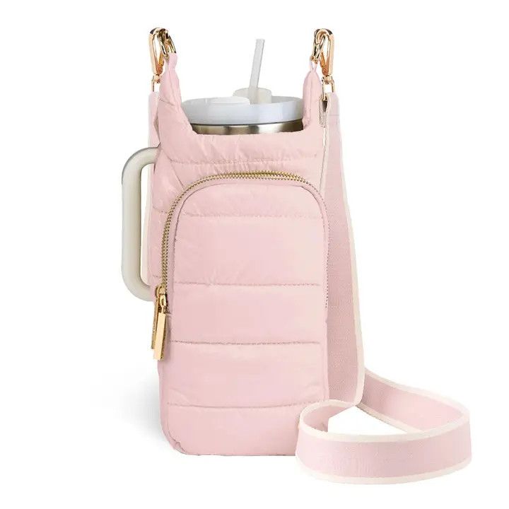 Blush quilted water bottle crossbody bag with adjustable woven strap and gold hardware.