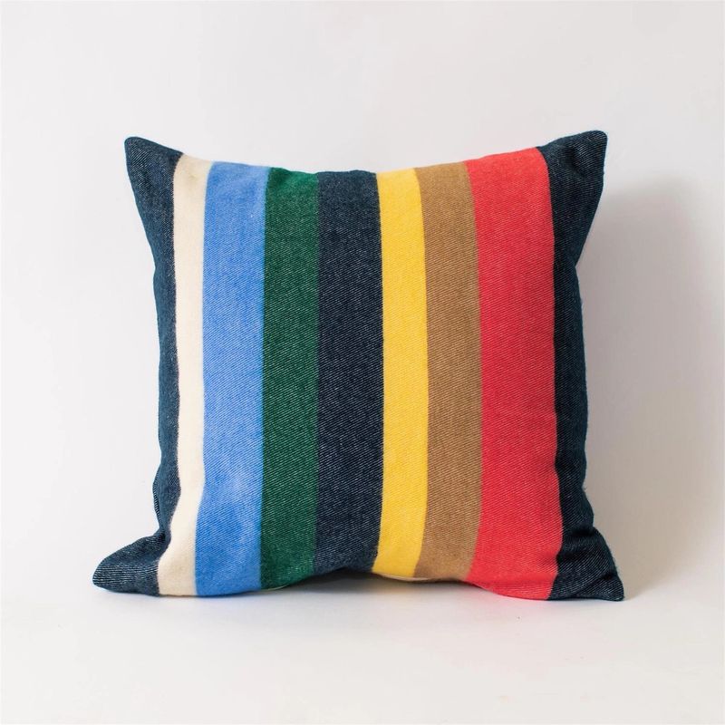 Square multi colored striped cotton throw pillow photographed on a white background.
