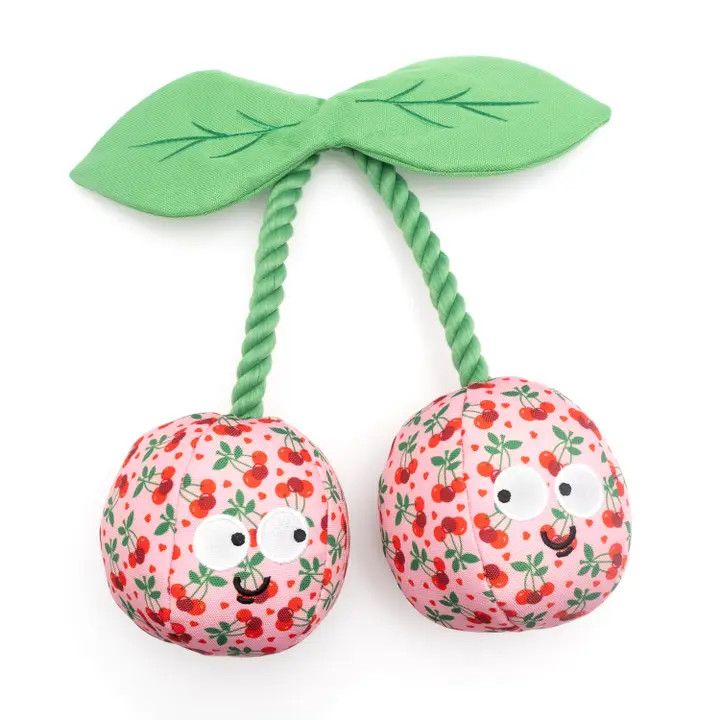 Plush cherry-shaped dog toy with pink cherry print fabric, green rope stem, and embroidered faces.