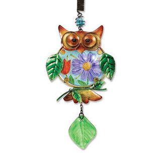 Colorful metal owl hanging decoration with floral design and green leaf charm attached to a spring.