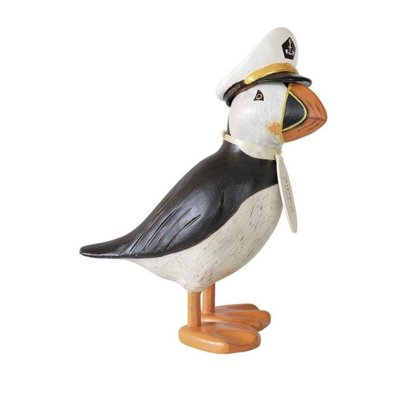 Hand-carved wooden puffin figurine with black and white body wearing a white captain’s cap.