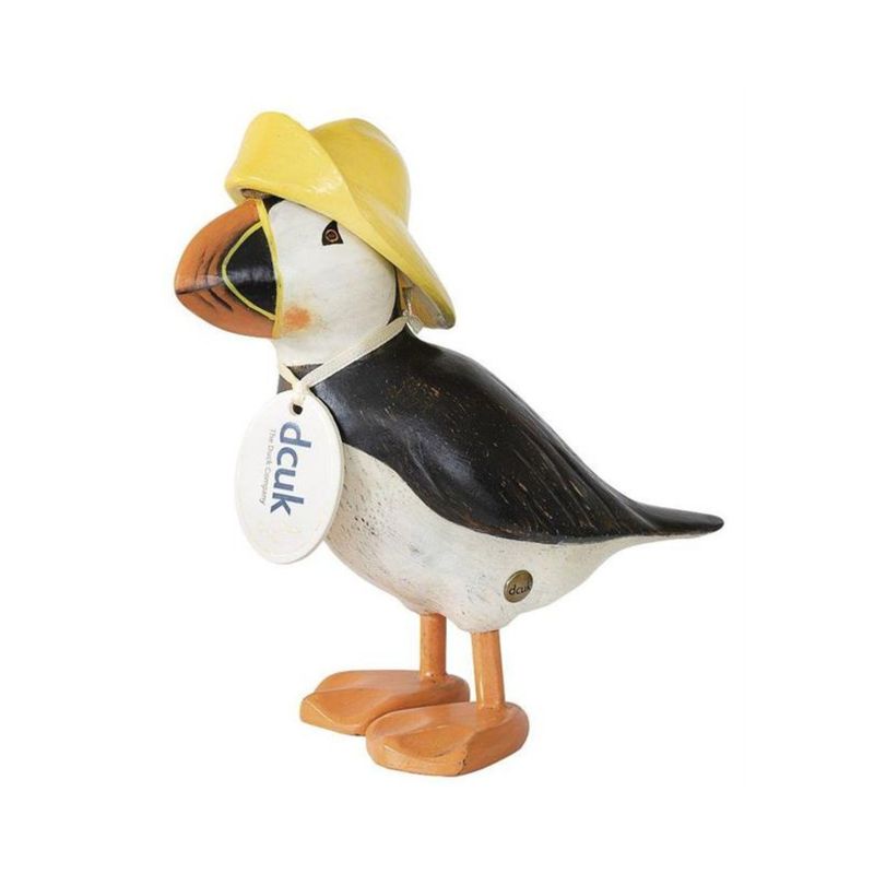 Hand-carved wooden puffin figurine wearing a yellow fisherman hat with hand-painted beak details.