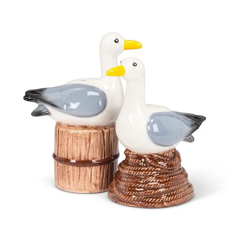Ceramic salt and pepper shakers shaped like seagulls perching on brown textured bases.
