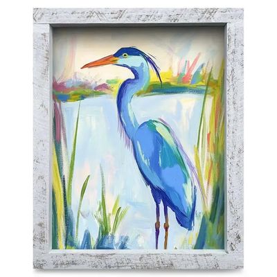 framed paper art print featuring a detailed watercolor illustration of a graceful blue heron standing in calm coastal waters.