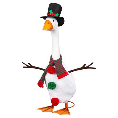 Giddy the Porch Goose in a snowman costume with branch-shaped arms, red and green pom-pom buttons, a striped scarf, and top h