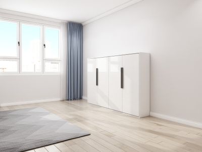 High-glossy white murphy bed in a horizontal style which is folded up in a cabinet position for discreet design.