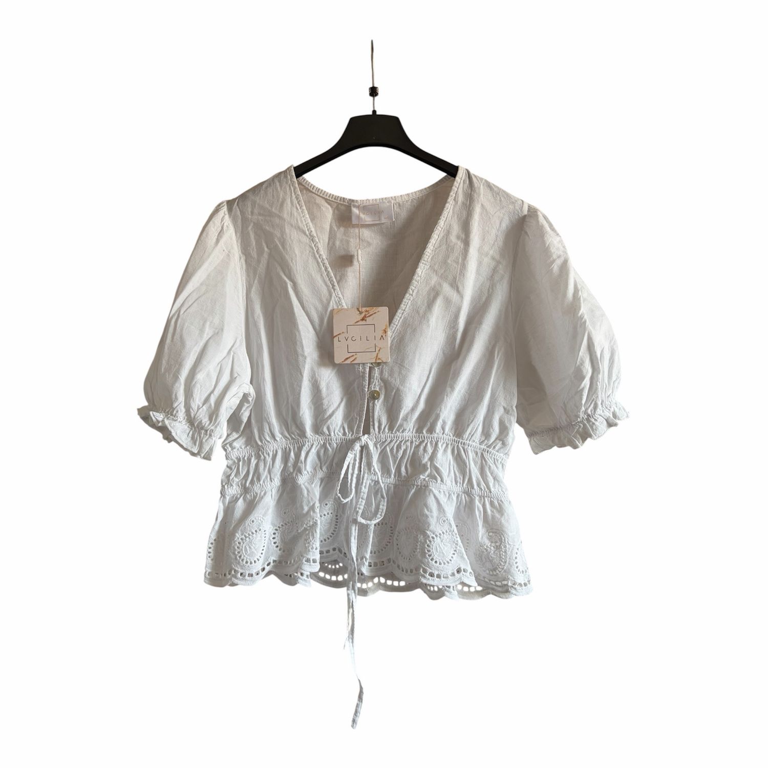 V-hals blouse met broderie en strikdetail